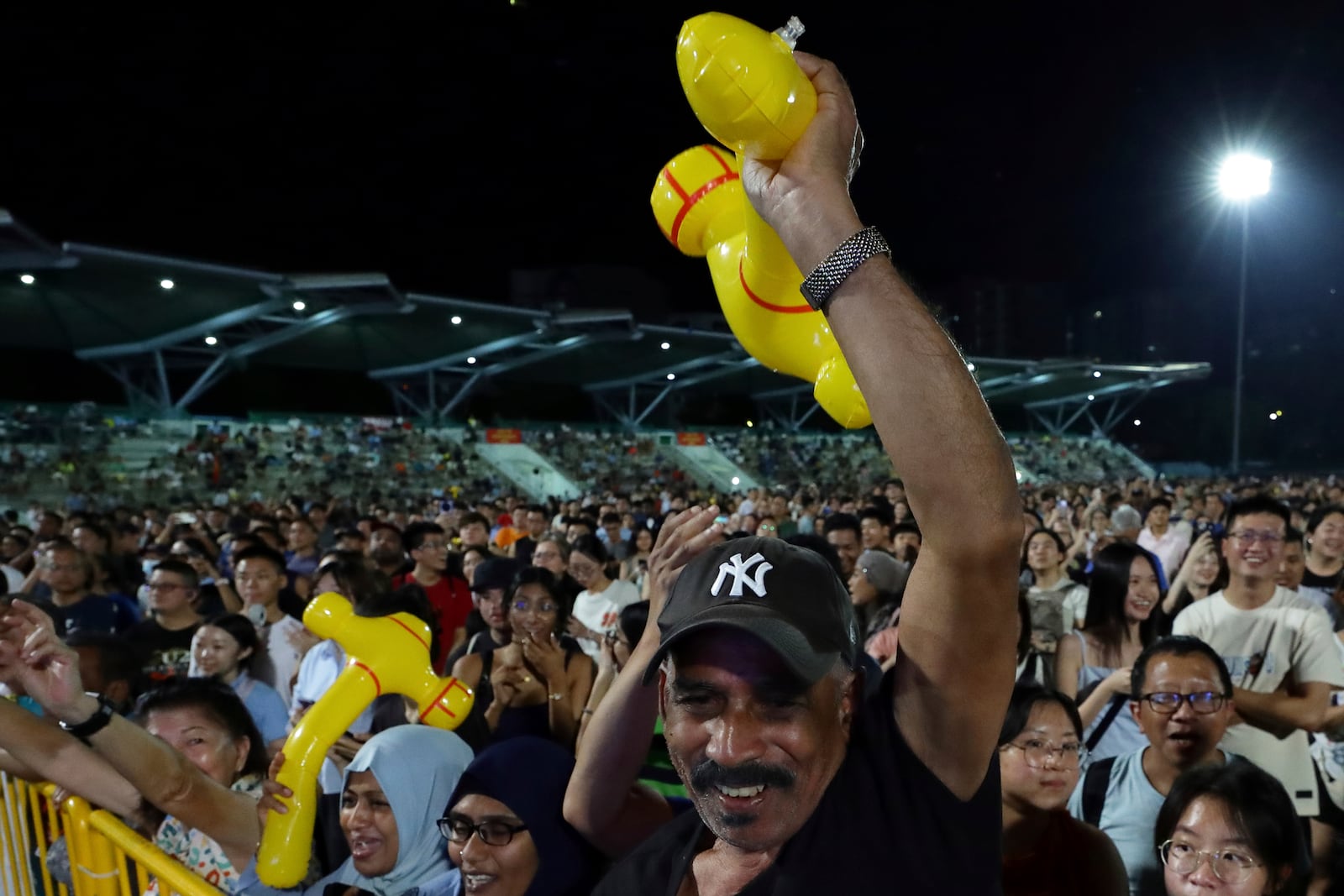 Workers' Party (WP) supporters react at an assembly centre during the general election, in Singapore, Saturday, May 3, 2025. (AP Photo/Suhaimi Abdullah)