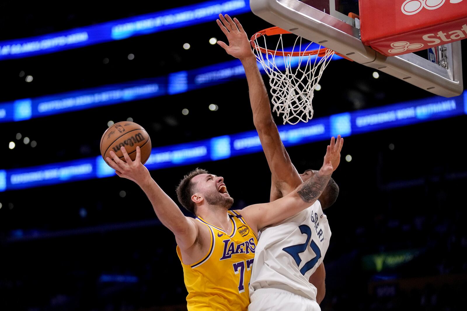 Los Angeles Lakers guard Luka Doncic (77) goes to the basket against Minnesota Timberwolves center Rudy Gobert (27) during the first half of Game 2 of an NBA first-round playoff series in Los Angeles, Tuesday, April 22, 2025. (AP Photo/Eric Thayer)