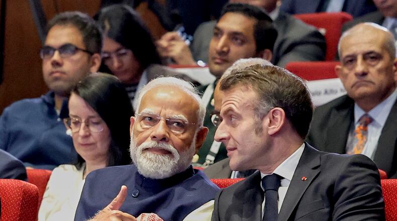 India's Prime Minister Narendra Modi, left, talks with French President Emmanuel Macron during the AI Summit in New Delhi, India, Thursday, Feb.19, 2026. (Indian Prime Minister's Office via AP)