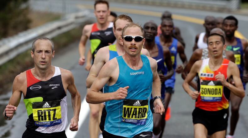 FILE - In this April 15, 2019, file photo, Jared Ward, center, of Mapleton, Utah, leads the pack during the 123rd running of the Boston Marathon in Natick, Mass. Elite runners competing in teams of three from places like Zimbabwe, Peru, Ecuador and across the U.S. will take the starting line Saturday, Sept. 12, 2020, for a unique sort of marathon relay race. Ward will be among the participants as he and his teammates race on their home course in Utah.(AP Photo/Steven Senne, File)