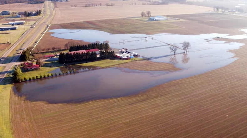This farm along Ohio 42 in Spring Valley was surrounded by flood waters after a several days of rain. TY GREENLEES / STAFF