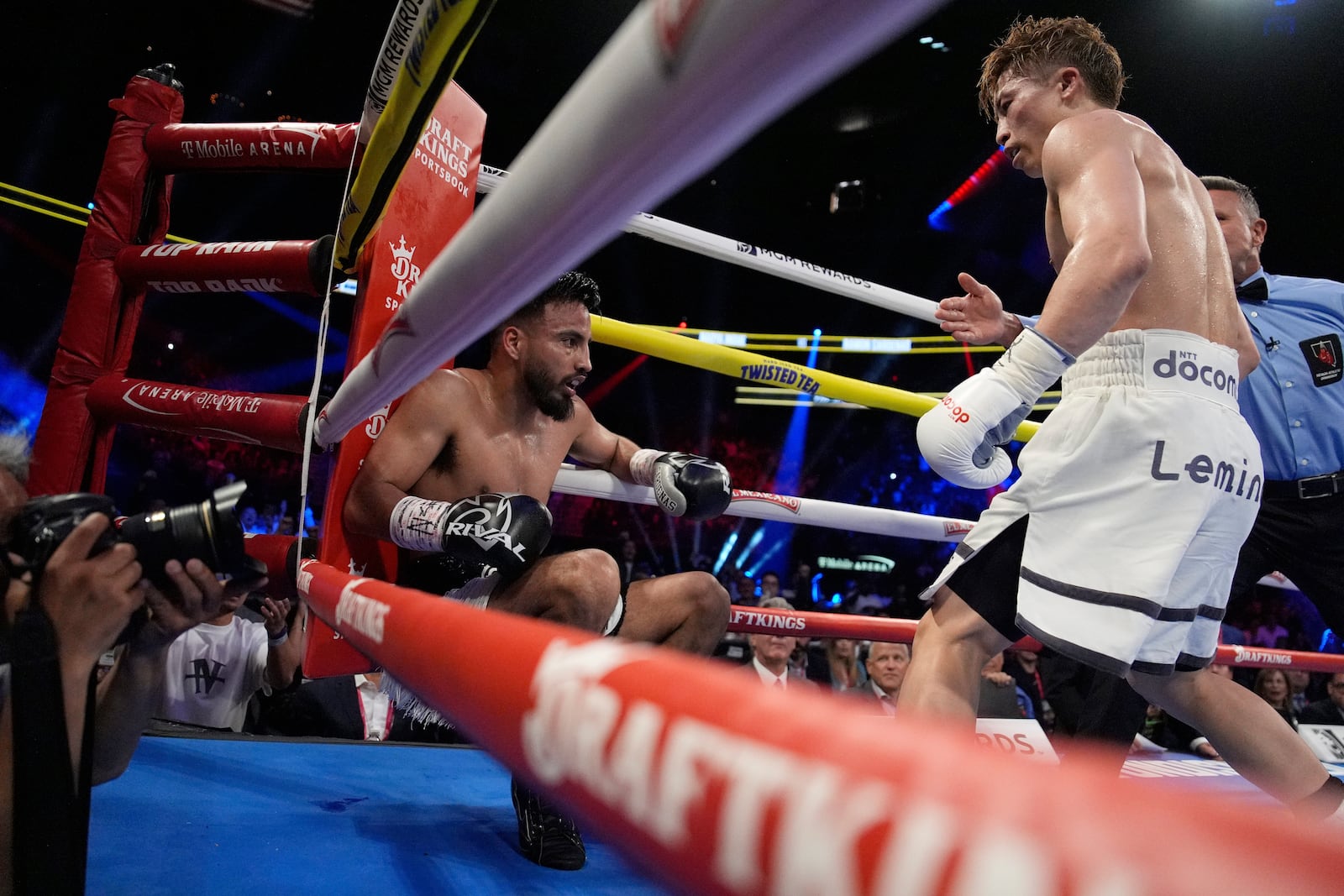 Naoya Inoue, right, knocks down Ramon Cardenas in a junior featherweight title boxing match Sunday, May 4, 2025, in Las Vegas. (AP Photo/John Locher)
