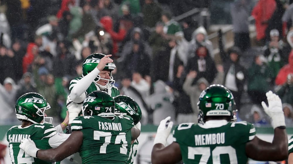 New York Jets place kicker Nick Folk (6) celebrates with teammates after he kicked the game-winning field goal against the Atlanta Falcons during the second half of an NFL football game, Sunday, Nov. 30, 2025, in East Rutherford, N.J. (AP Photo/Adam Hunger)