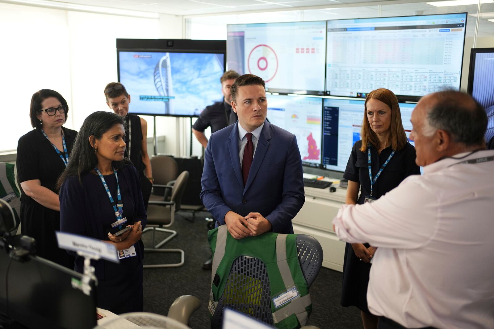 Britain's Health Secretary Wes Streeting, center, listens during a visit to NHS National Operations Centre to see how they manage industrial action, in London, Friday, July 25, 2025. (Jordan Pettitt/PA via AP)