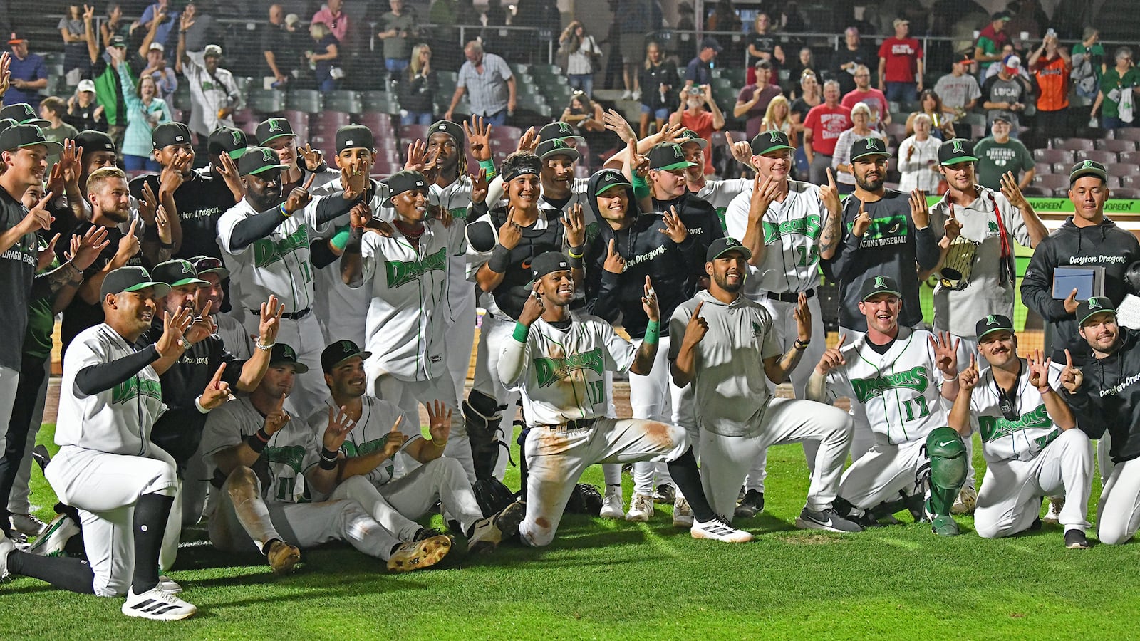 The Dragons signal 1-4 to celebrate their club record 14-game winning streak Tuesday night at Day Air Ballpark after rallying in the eighth inning to defeat Lansing 4-3. JEFF GILBERT/CONTRIBUTED