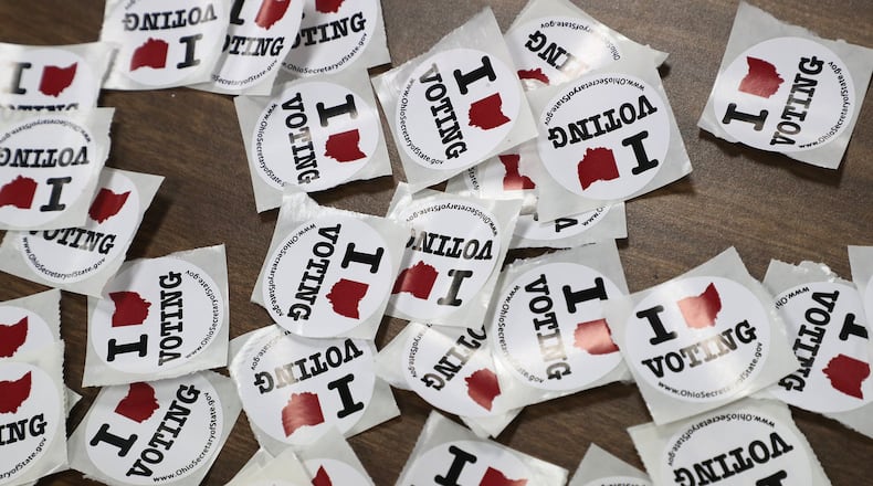 “I Love Voting” stickers wait for voters as they exit a Springfield election poll in 2020. BILL LACKEY/STAFF
