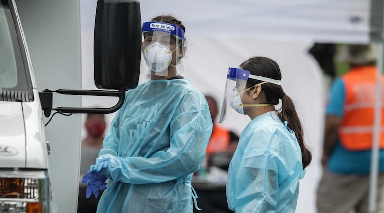 Members of Montgomery County Public Health and the Ohio National Guard help with pop-up testing Tuesday, Aug. 18, 2020, at Kettering Fields, 444 North Bend Blvd. Results from the latest coronavirus pop-up testing site are expected in a more timely manner and results are accessible online to patients, following a switch to a new laboratory. JIM NOELKER/STAFF