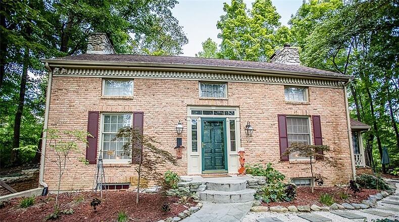 The brick, 2-story home features about 1,730 sq. ft. of living space has 3 bedrooms and a full, finished, walk-out basement. A stone staircase leads to the front door and the detached, 2-car garage. CONTRIBUTED PHOTO