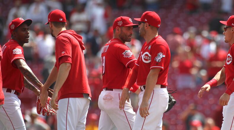 The Reds celebrate a victory against the Pirates on Wednesday, July 31, 2019, at Great American Ball Park in Cincinnati. David Jablonski/Staff