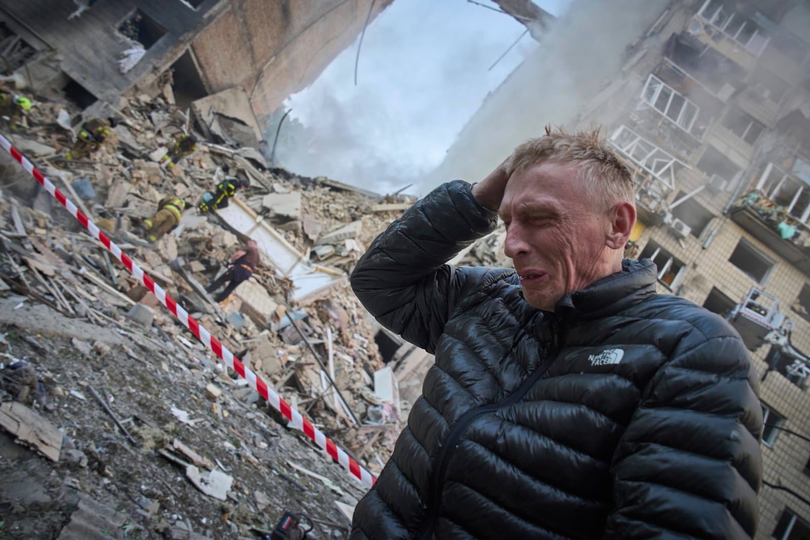 A resident reacts after a Russian missile hit a multi-storey apartment during Russia's massive missile and drone air attack in Kyiv, Ukraine, Tuesday, June 17, 2025. (AP Photo/Efrem Lukatsky)