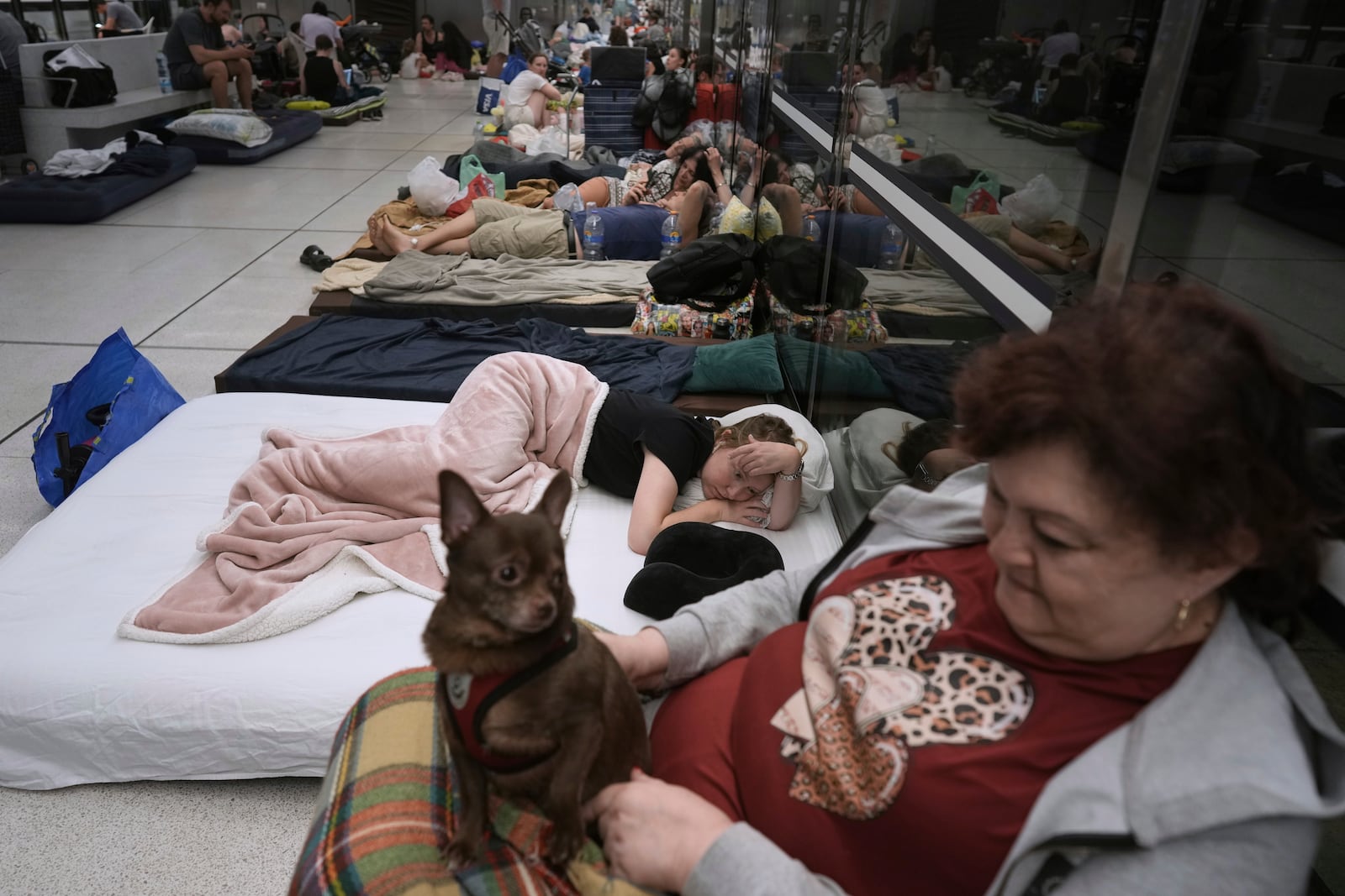 People take shelter in an underground metro station in prevention of Iran missile attacks, in Ramat Gan, near Tel Aviv, Israel, Tuesday, June 17, 2025. (AP Photo/Oded Balilty)