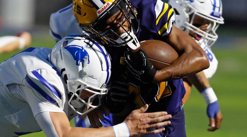 Springfield's Amileo Norvell is pushed out of bounds by Springboro's Evan Weinberg during Friday night's game. BILL LACKEY/STAFF