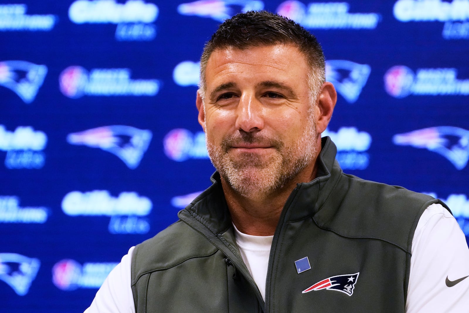 New England Patriots head coach Mike Vrabel smiles during a media availability prior to the NFL football team's rookie minicamp, Friday, May 9, 2025, in Foxborough, Mass. (AP Photo/Charles Krupa)