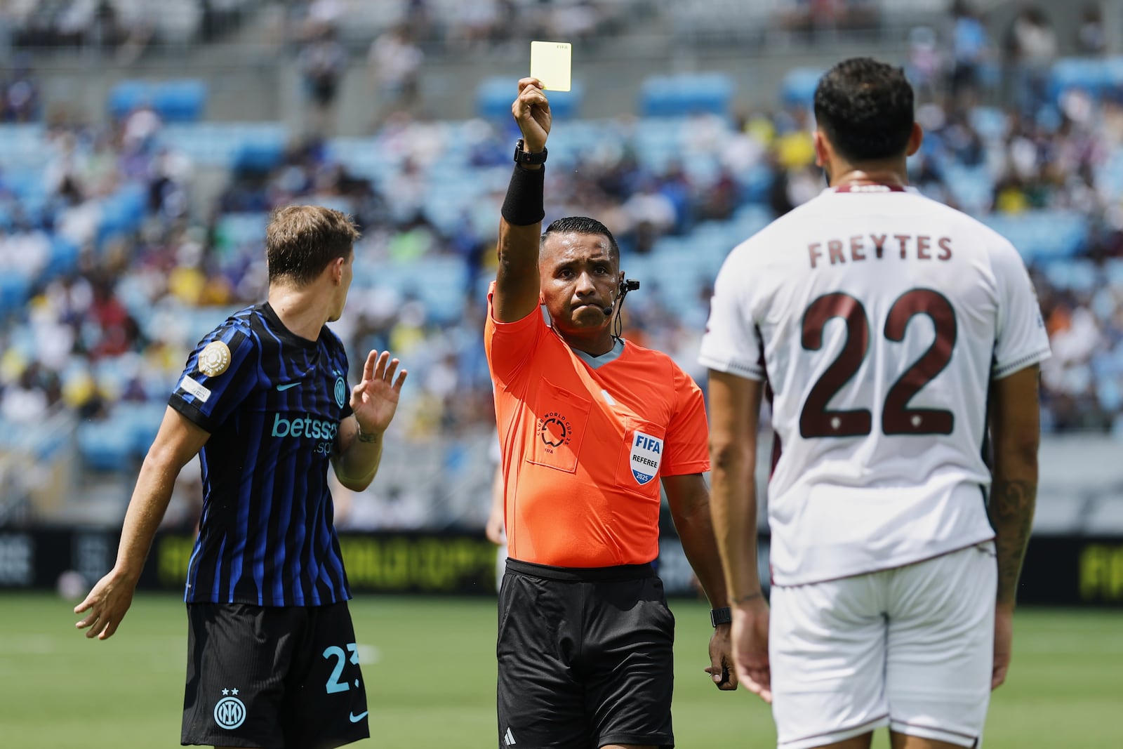referee Ivan Arcides Barton Cisneros, of El Salvador, issues a yellow card to Fluminense's Juan Pablo Freytes (22) during the Club World Cup round of 16 soccer match between Inter Milan and Fluminense in Charlotte, N.C., Monday, June 30, 2025. (AP Photo/Nell Redmond)