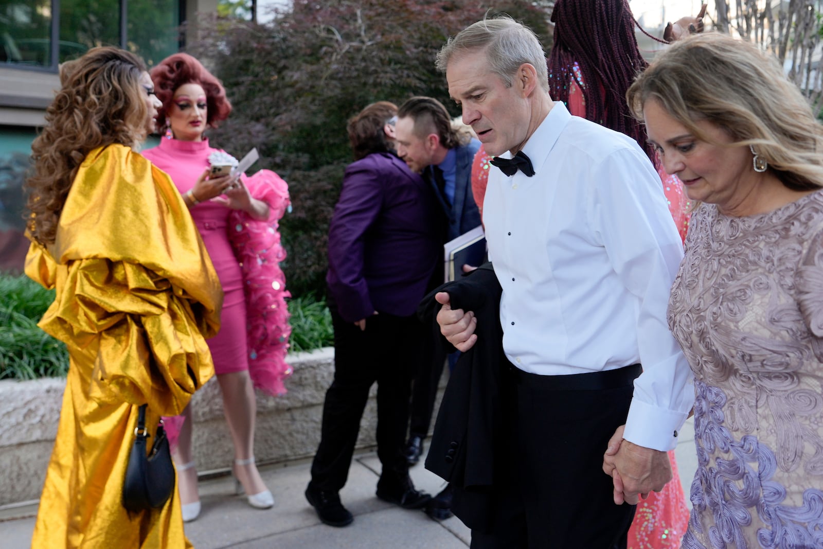 Rep. Jim Jordan, R-Ohio, and Polly Jordan walk past Tara Hoot, Ricky Rosé, Vagenesis and Maria Con Carne outside the Kennedy Center, to attend Les Miserables, Wednesday, June 11, 2025, in Washington, on the night that President Donald Trump and first lady Melania Trump were also attending. (AP Photo/Julia Demaree Nikhinson)