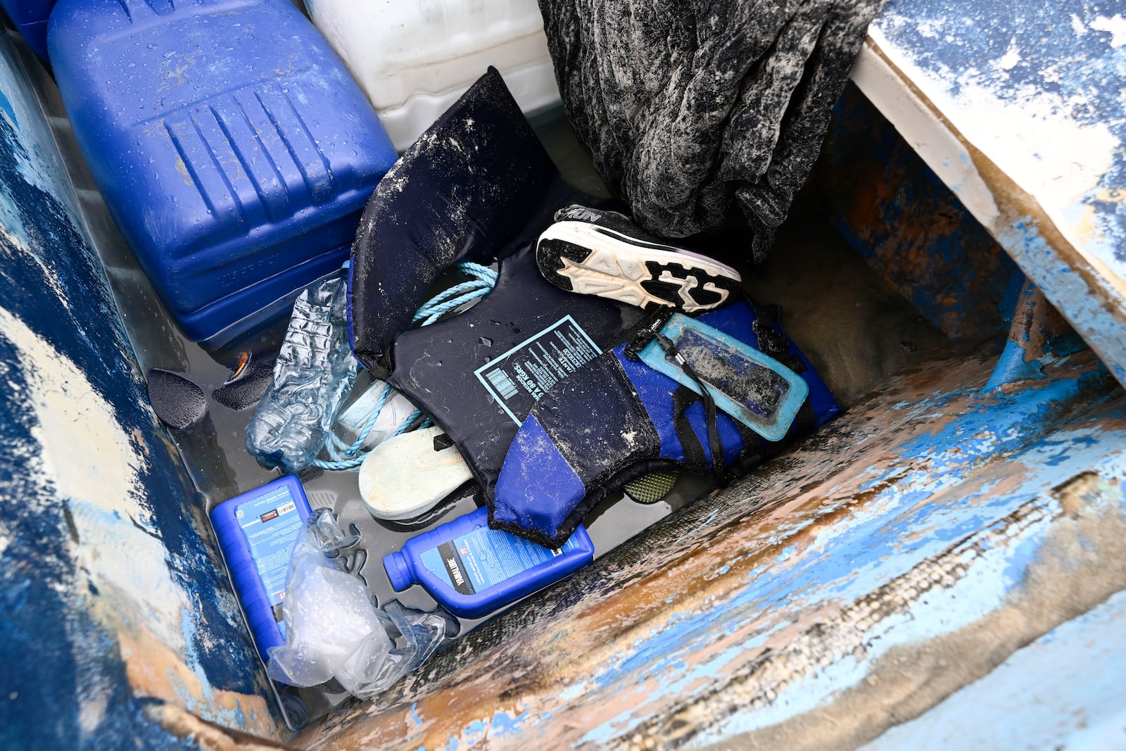 Life jackets and personal items are seen in a boat that capsized Monday, May 5, 2025, at Torrey Pines State beach in San Diego. (AP Photo/Denis Poroy)