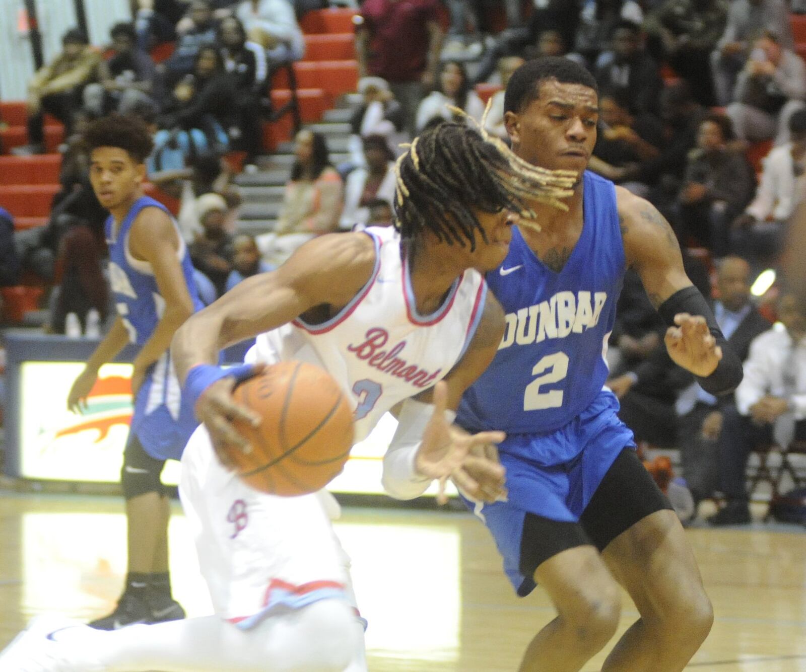 Belmont’s Jadon Furlow (with ball) and Dunbar’s Joseph Scates. Dunbar defeated host Belmont 58-57 in a boys high school basketball game on Fri., Jan. 26, 2018. MARC PENDLETON / STAFF