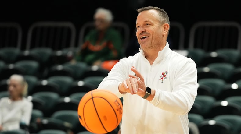 Louisville head coach Jeff Walz puts the ball back into play during the second half of an NCAA college basketball game against Miami, Thursday, Jan. 8, 2026, in Coral Gables, Fla. (AP Photo/Lynne Sladky)