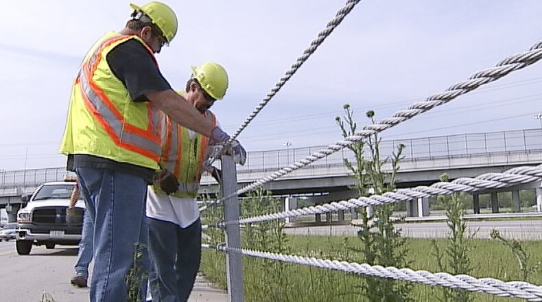 Ohio Department of Transportation workers repair safety cables on I-675 between U.S. 35 and North Fairfield Road on Monday, May 7. WHIO-TV PHOTO BY CHUCK HAMLIN
