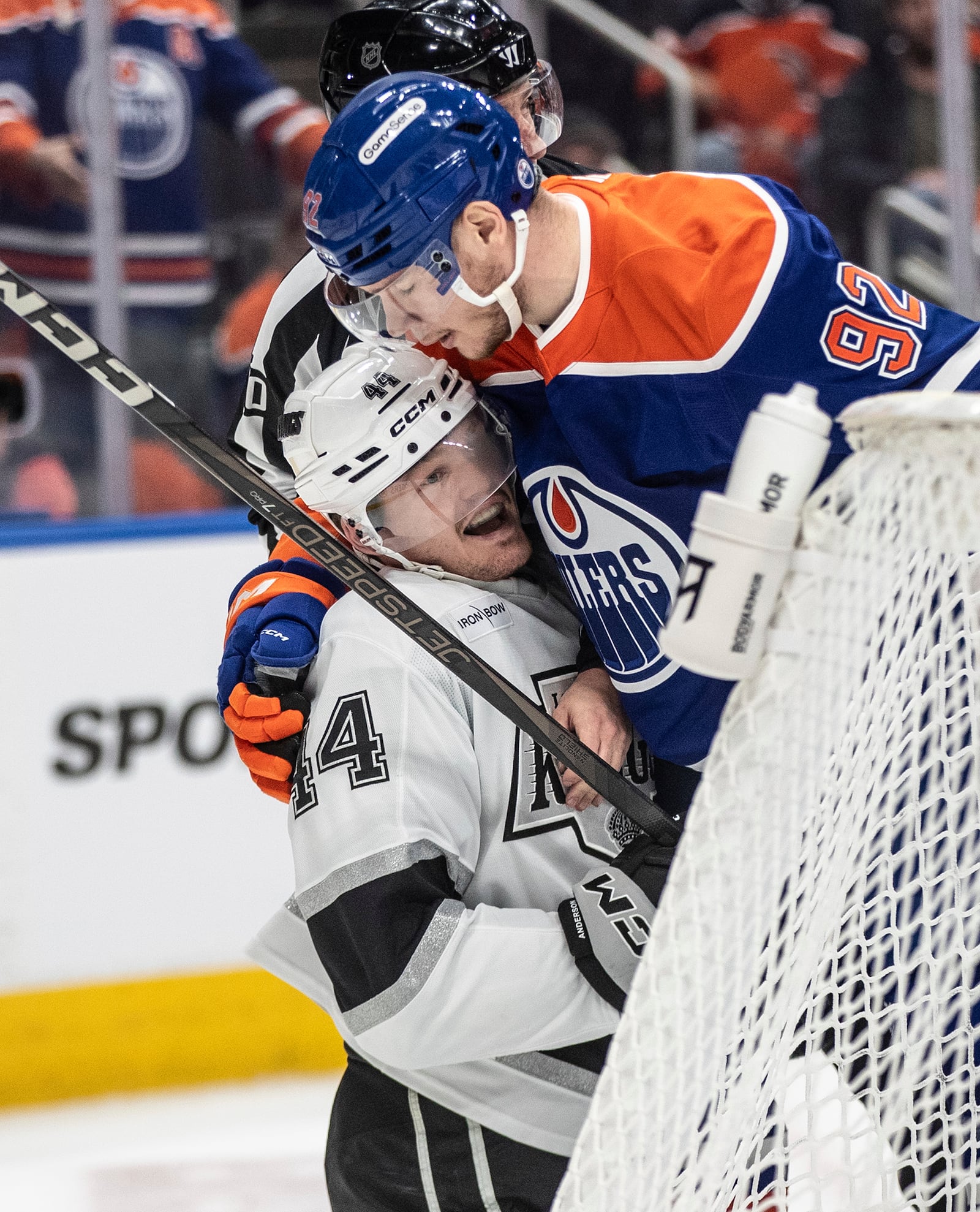 Los Angeles Kings' Mikey Anderson (44) and Edmonton Oilers' Vasily Podkolzin (92) rough it up during the first period of Game 6 of an NHL hockey first-round playoff series in Edmonton, Alberta, Thursday, May 1, 2025. (Jason Franson/The Canadian Press via AP)