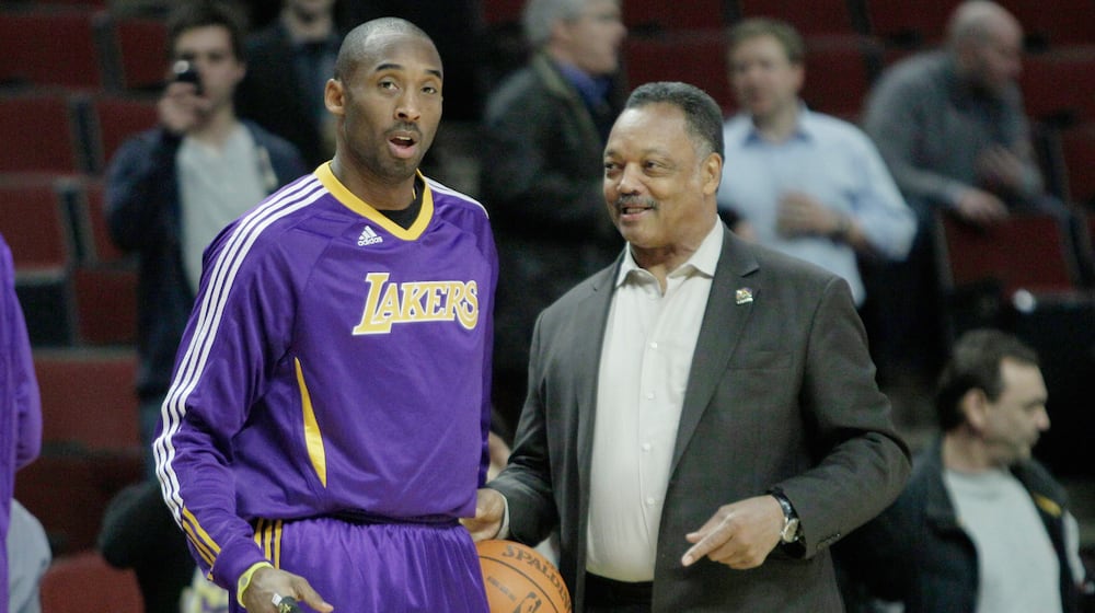 FILE - The Rev. Jesse Jackson, right, talks to Los Angeles Lakers' Kobe Bryant during warmups before an NBA basketball game against the Chicago Bulls in Chicago, Friday, Dec. 10, 2010. (AP Photo/Nam Y. Huh, File)