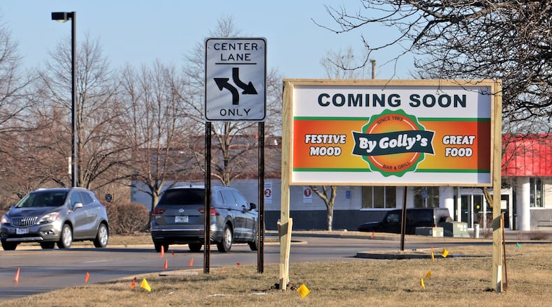 A new sign along Bechtle Avenue announces that a By Golly's restaurant is moving into the former Roosters location Monday, March 10, 2025. BILL LACKEY/STAFF