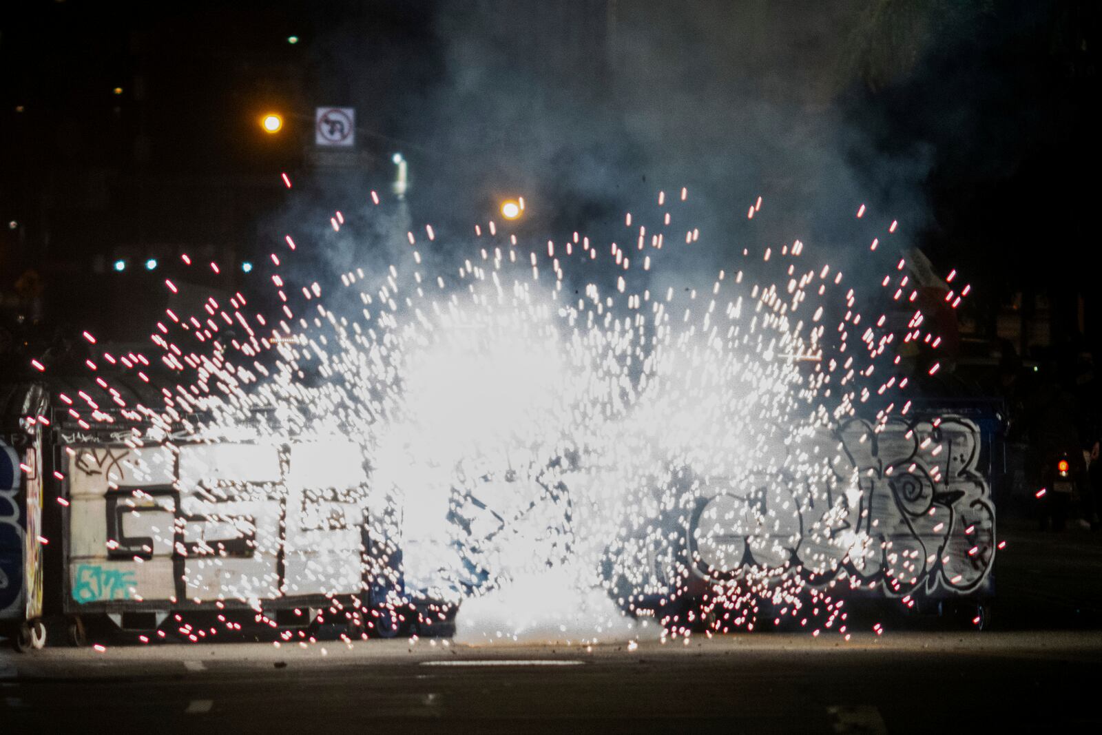 Fireworks explode during protests over the Trump administration's immigration raids in Los Angeles, Monday, June 9, 2025. (AP Photo/Ethan Swope)