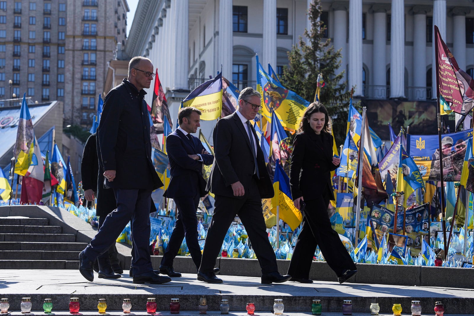 From left, German Chancellor Friedrich Merz, French President Emmanuel Macron and U.K. Prime Minister Keir Starmer, walk in front of the memorial of fallen Ukrainian soldiers at independence square in Kyiv, Ukraine, on Saturday, May 10, 2025. (AP Photo/Evgeniy Maloletka)