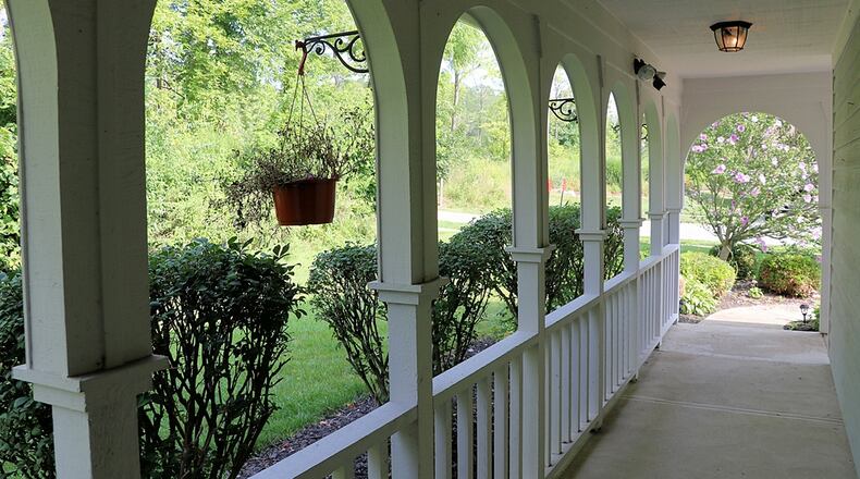 A wrap-around front porch leads to the formal front entry way, and a tree-lined neighboring park provides some added privacy. Contributed photos by Kathy Tyler