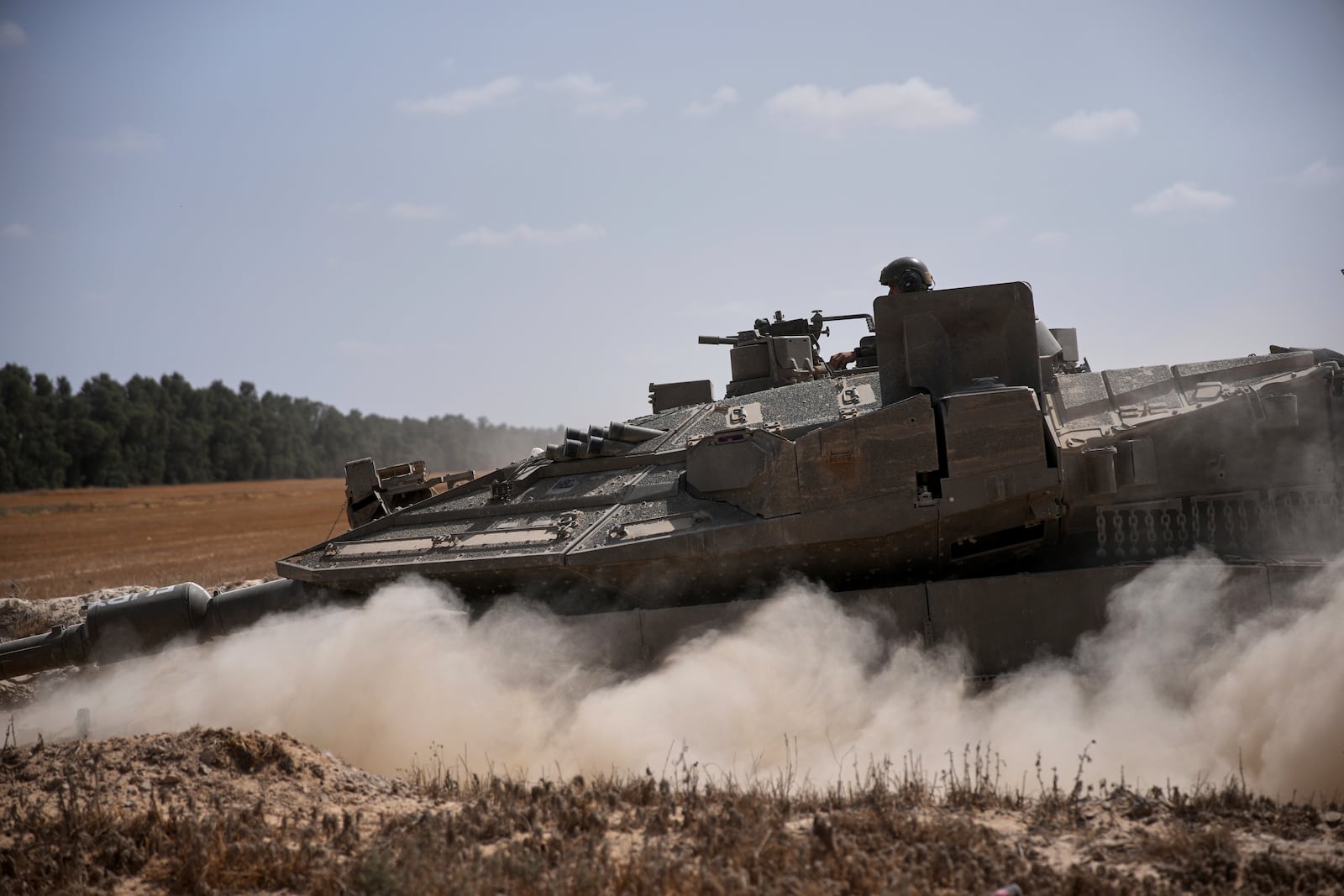 Israeli forces move along the border with the Gaza Strip, in southern Israel, Monday, May 19, 2025. (AP Photo/Ohad Zwigenberg)
