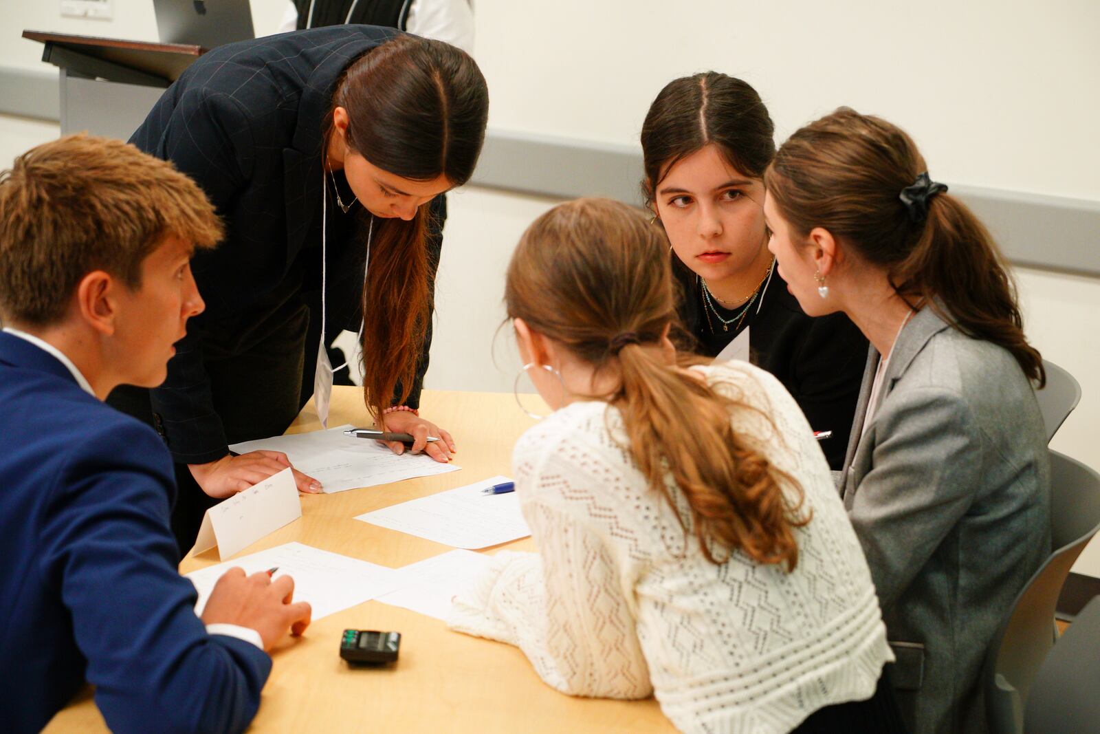 Kate Kruger, facing camera, and other students from Atlanta's Midtown High School confer during a semifinal round of the National High School Ethics Bowl in Chapel Hill, N.C., on Sunday, April 13, 2025. (AP Photo/Allen G. Breed)
