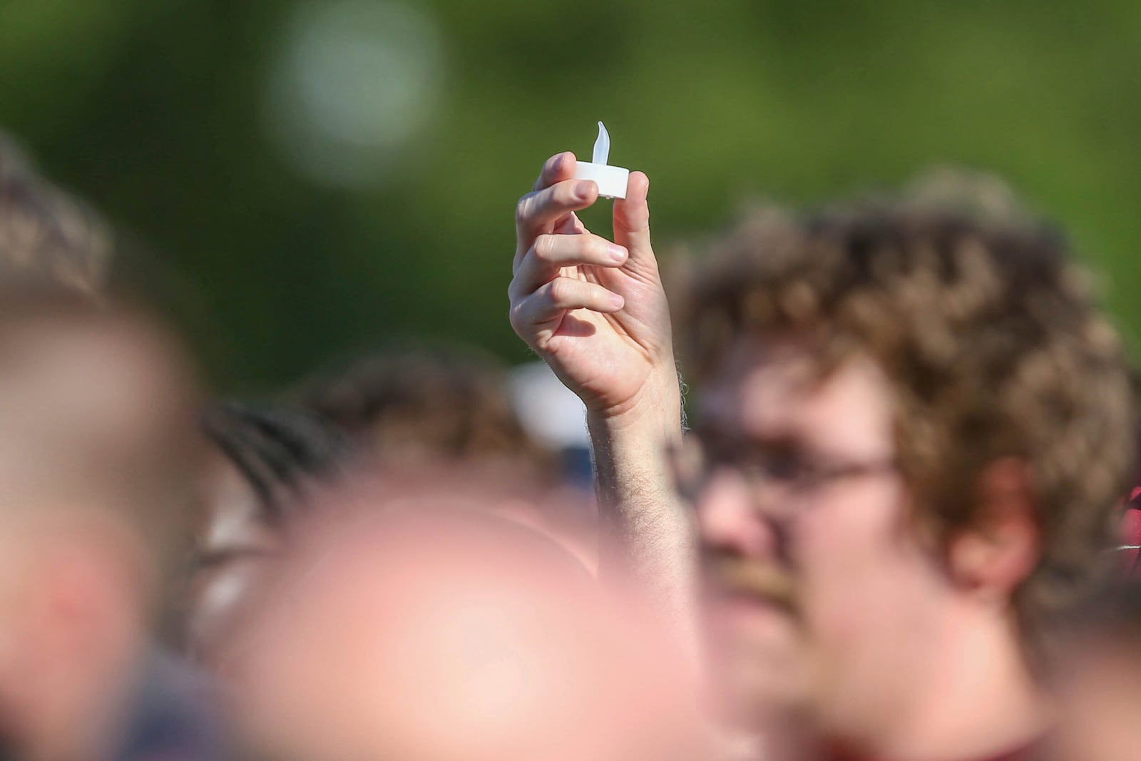Electronic candles are lifted during a vigil on the Florida State campus at Langford Green, Tallahassee, Fla., Friday, April 18, 2025. (AP Photo/Gary McCullough)