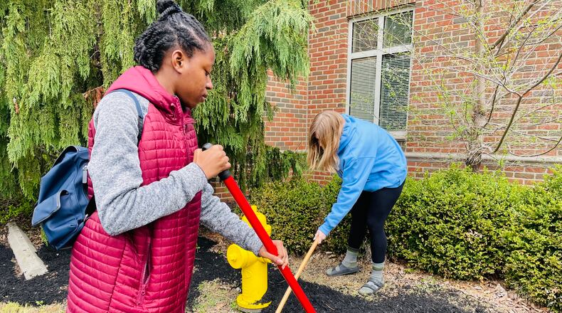 Students tend to the gardens of buildings at the Oesterlen campus in Springfield Friday as a part of the countywide service day. Photo provided by Niki Sage.