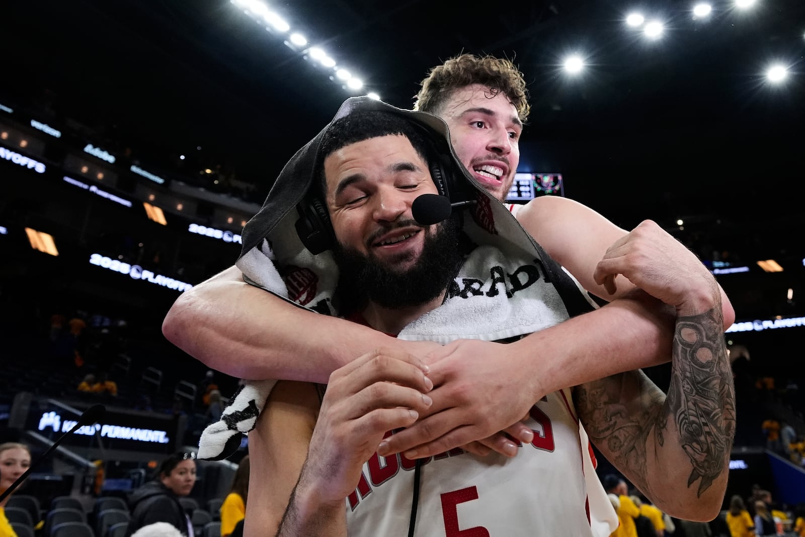 Houston Rockets guard Fred VanVleet (5) is hugged by center Alperen Sengun after the team's victory over the Golden State Warriors in Game 6 of an NBA basketball first-round playoff series Friday, May 2, 2025, in San Francisco. (AP Photo/Godofredo A. Vásquez)