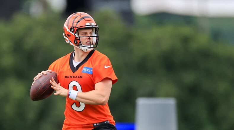 Cincinnati Bengals' Joe Burrow looks to pass during an NFL football camp practice in Cincinnati, Tuesday, June 8, 2021. (AP Photo/Aaron Doster)