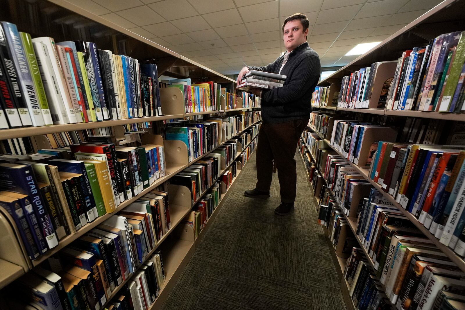 Spencer Davis, one of several librarians slated to be laid off due to DOGE cuts, works at the Maine State Library, Wednesday, May 7, 2025, in Augusta, Maine. (AP Photo/Robert F. Bukaty)