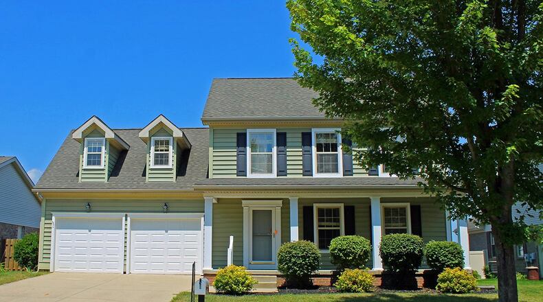 Offering a covered front porch, the 3-bedroom home has about 1,980 sq. ft. of living space. There is a bonus room above the 2-car garage. CONTRIBUTED PHOTO BY VICKIE KAPNAS