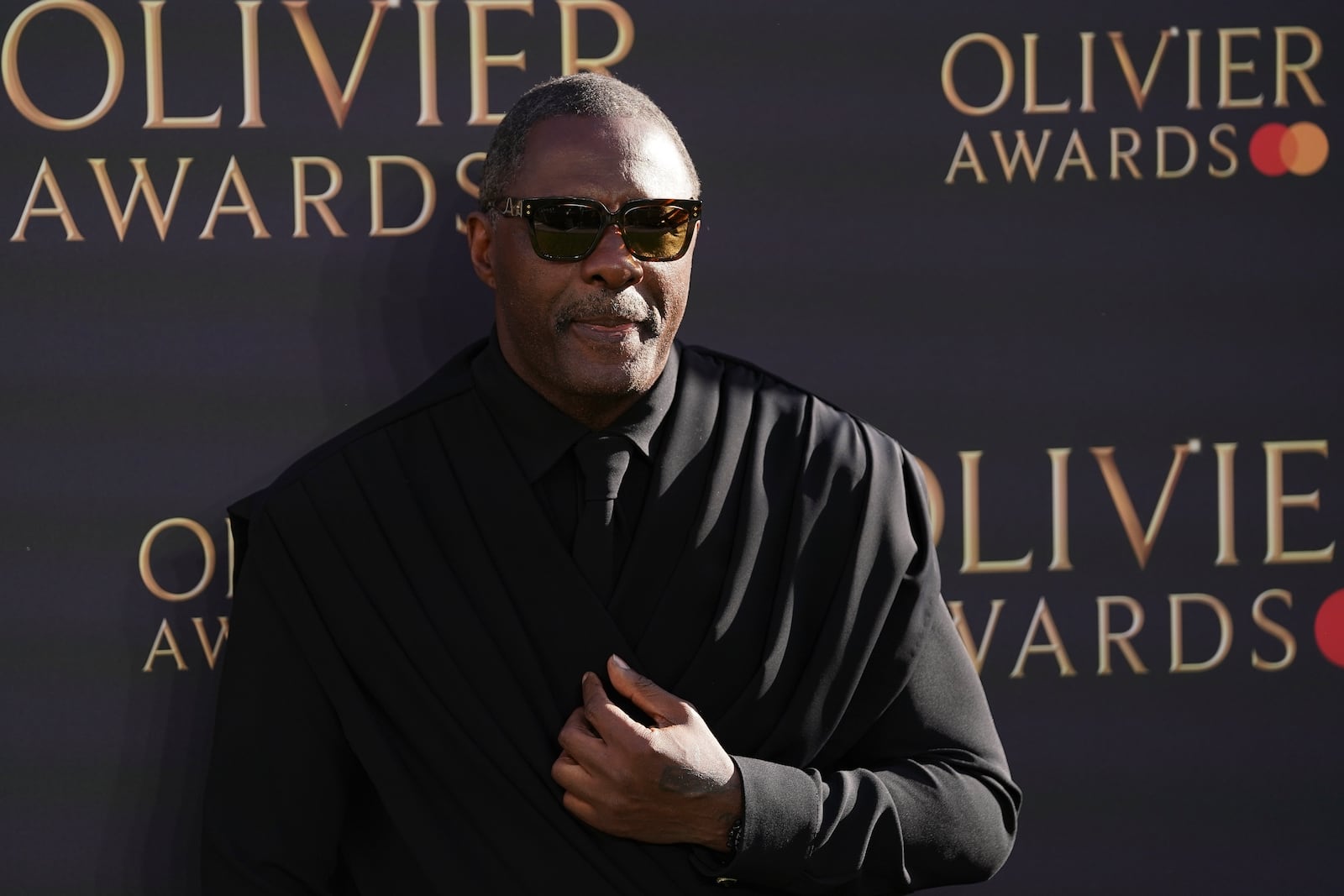 Idris Elba poses for photographers upon arrival at the Olivier Awards on Sunday, April 6, 2025, in London. (Photo by Alberto Pezzali/Invision/AP)