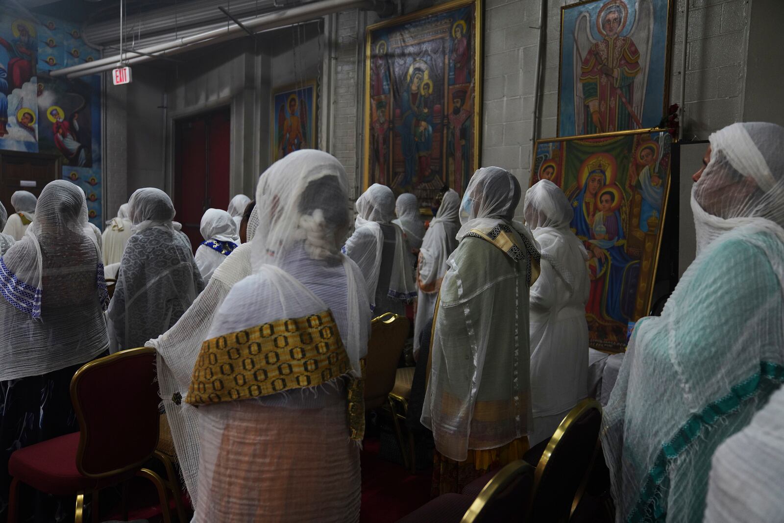 Congregants wear netela, a white scarf-like cotton cloth that signifies modesty and purity, during a service at Re'ese Adbarat Debre Selam Kidist Mariam Church, an Ethiopian Orthodox Tewahedo church, in Washington, D.C., Saturday, April 5, 2025. (AP Photo/Jessie Wardarski)