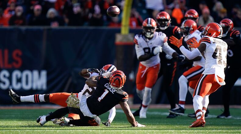 Cleveland Browns' John Johnson (43) recovers a fumble during the second half of an NFL football game against the Cincinnati Bengals, Sunday, Nov. 7, 2021, in Cincinnati. (AP Photo/Bryan Woolston)