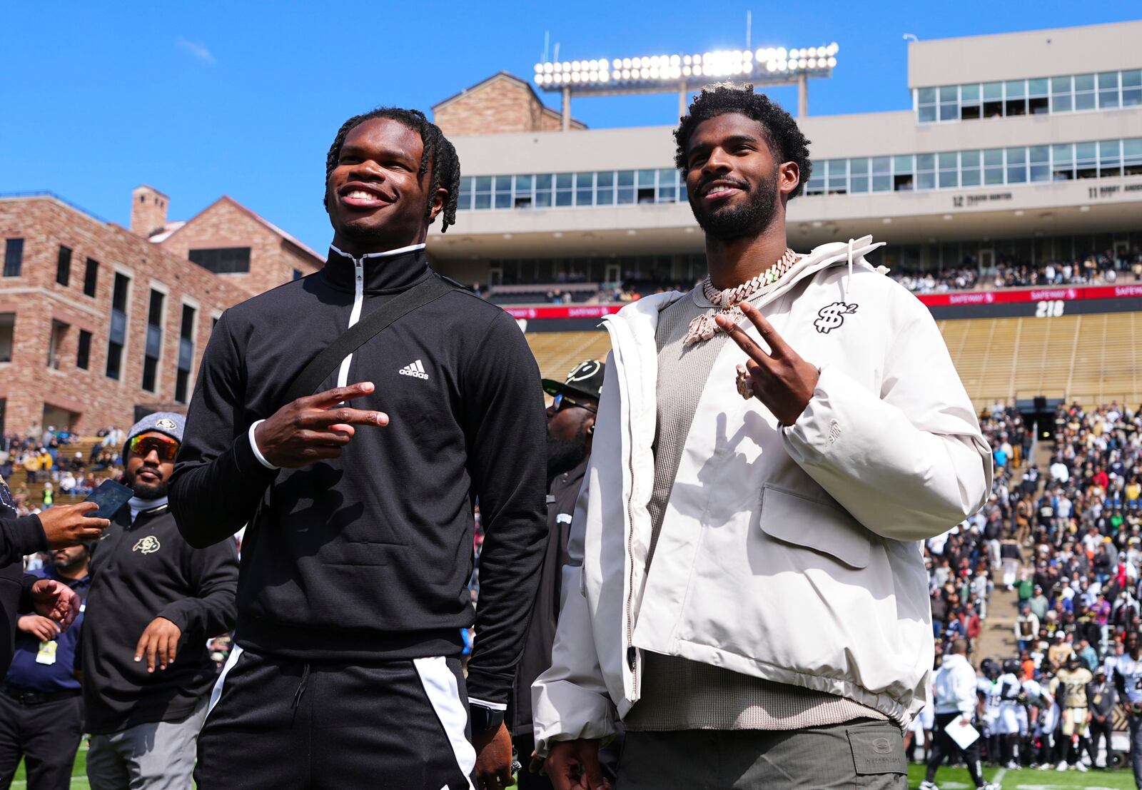 Travis Hunter, left, and Shedeur Sanders, right, react after their jersey retirements during the Colorado NCAA college football spring game, Saturday, April 19, 2025, in Boulder, Colo. (AP PhotoJack Dempsey)