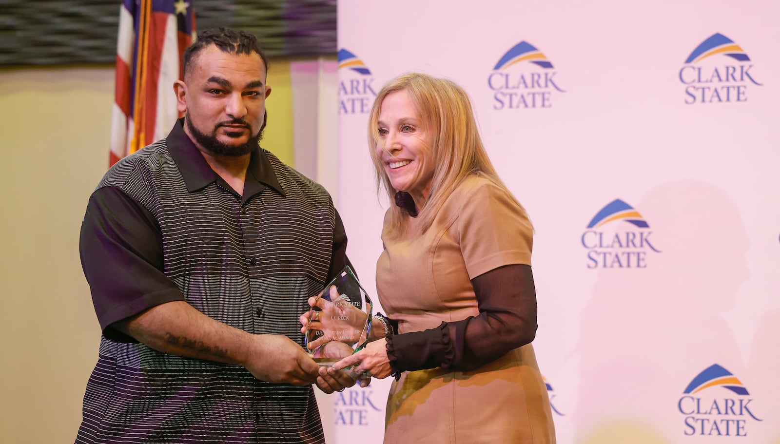 J.J. Peck receives the Martin Luther King, Jr. Award from Clark State President Jo Alice Blondin at Clark State College's annual MLK luncheon and awards ceremony at the Hollenbeck Bayley Center on Friday, Jan. 16, 2026, in Springfield. JOSEPH COOKE/STAFF