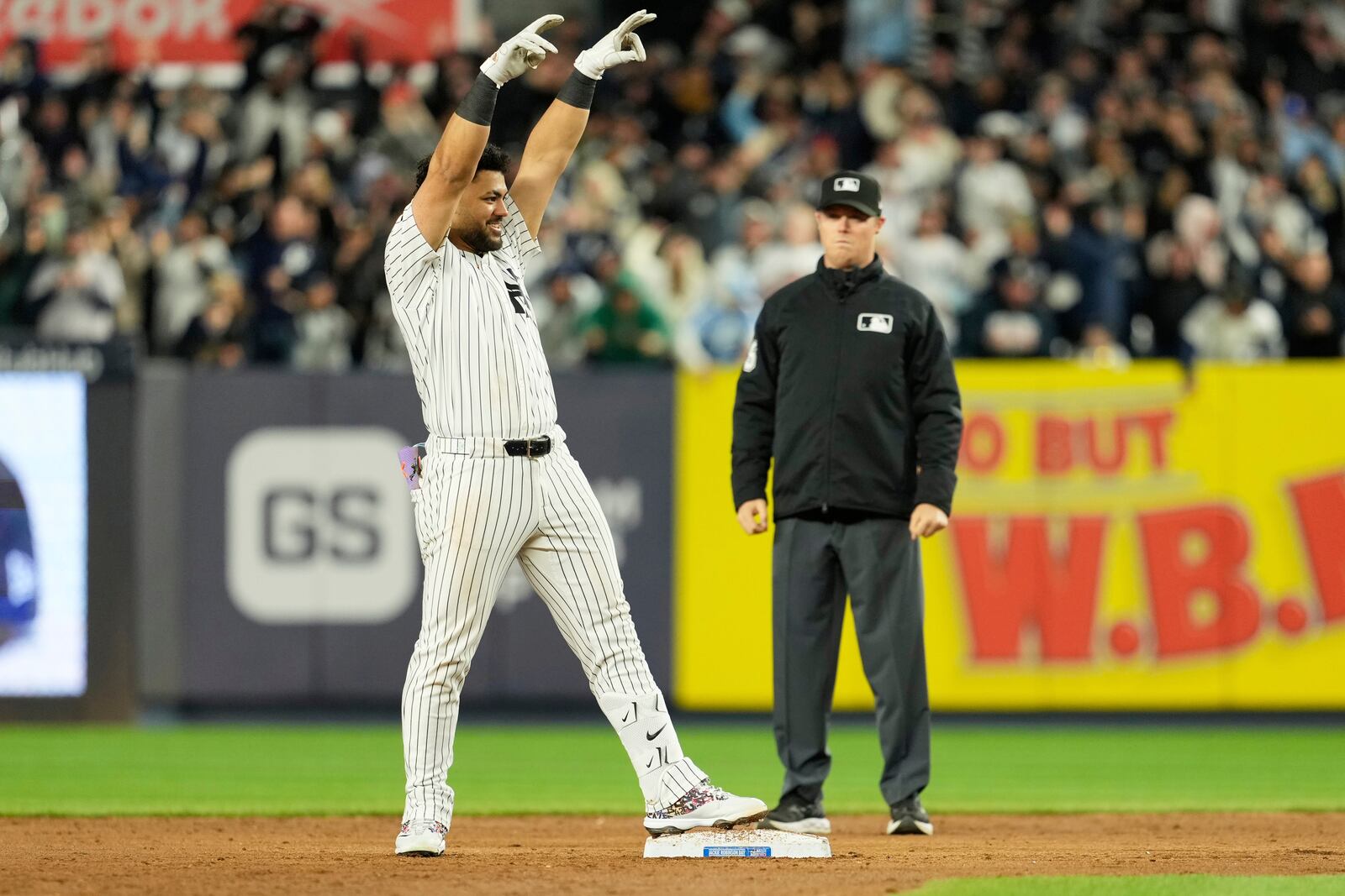 New York Yankees' Jasson Domínguez reacts after hitting a three-run double during the sixth inning of a baseball game Kansas City Royals Tuesday, April 15, 2025, in New York. All the players are wearing 42 in honor of Jackie Robinson Day. (AP Photo/Seth Wenig)