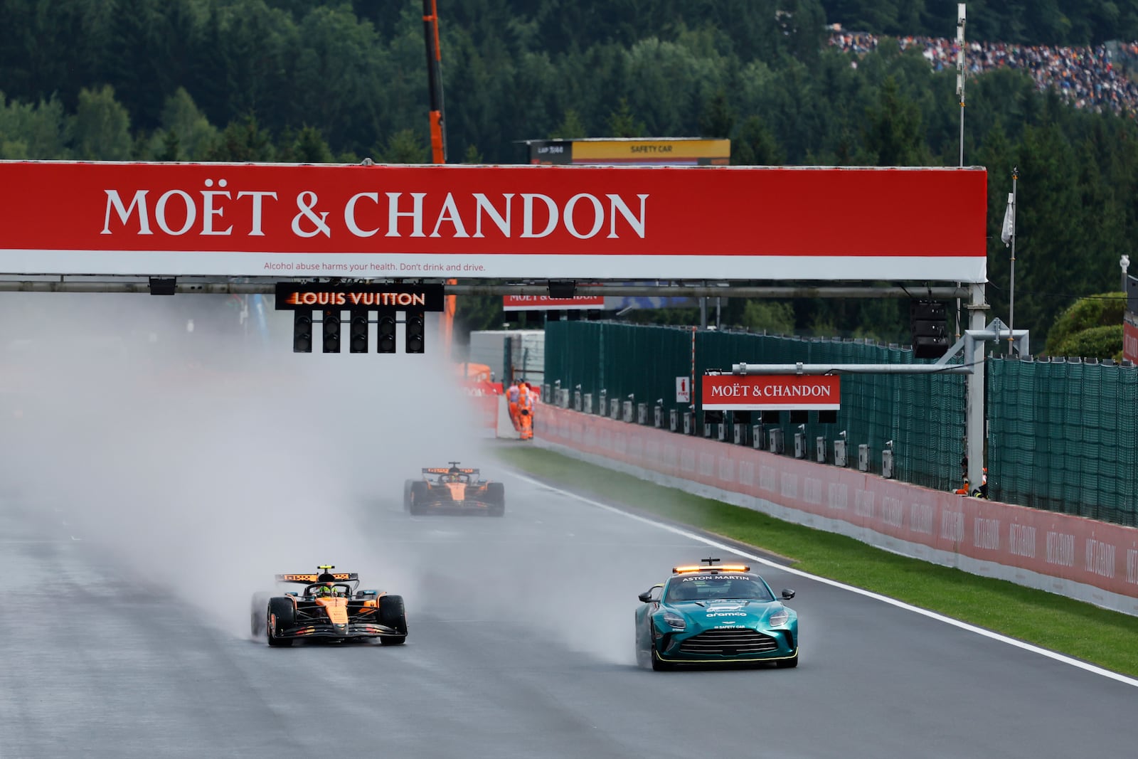 McLaren driver Lando Norris of Britain and McLaren driver Oscar Piastri of Australia steer their cars behind the safety vehicle at the start of the Formula One Grand Prix at the Spa-Francorchamps racetrack in Spa, Belgium, Sunday, July 27, 2025. (AP Photo/Geert Vanden Wijngaert)