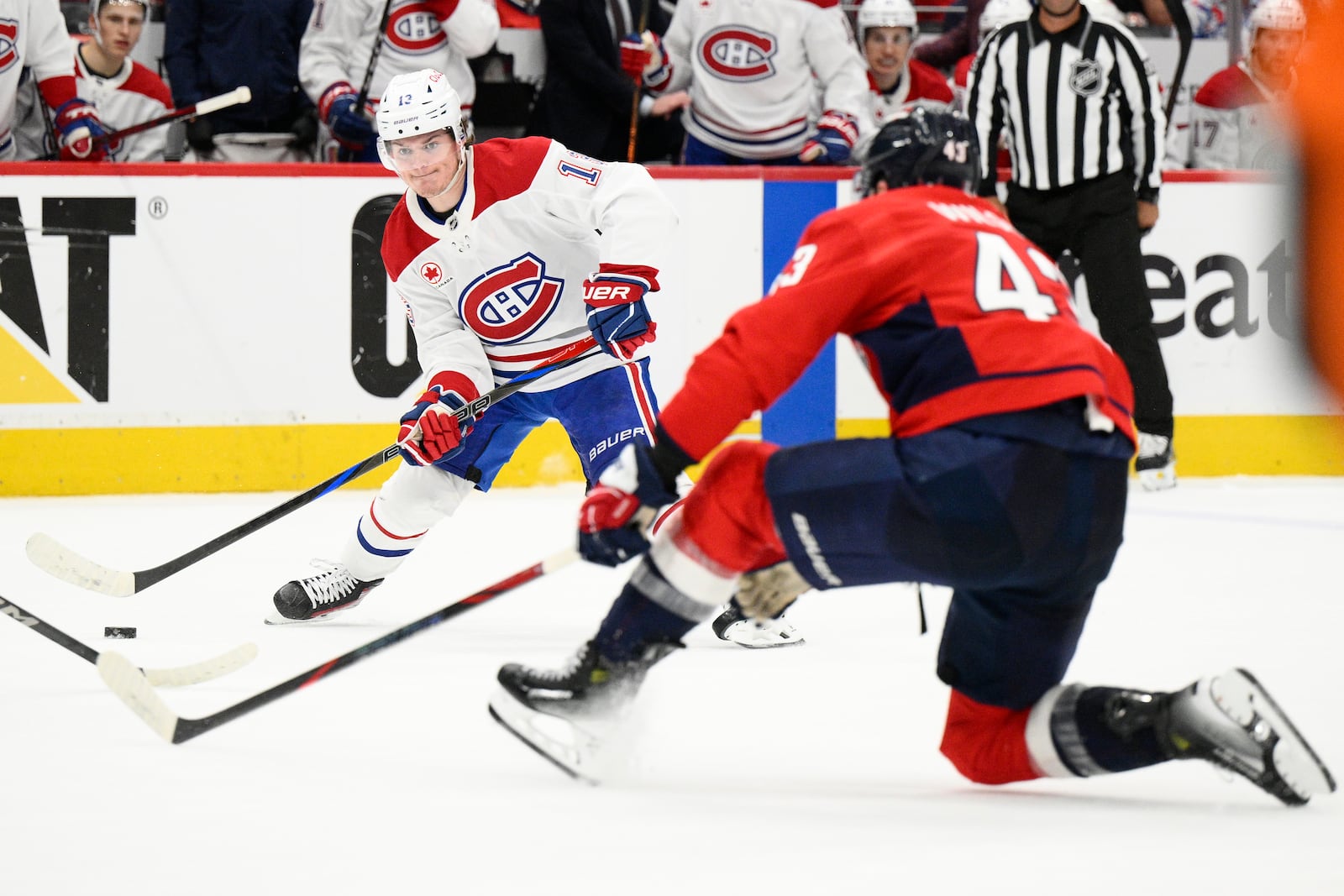 Montreal Canadiens right wing Cole Caufield (13) skates with the puck against Washington Capitals right wing Tom Wilson (43) in the second period of Game 5 of a first-round NHL hockey playoff series Wednesday, April 30, 2025, in Washington. (AP Photo/Nick Wass)