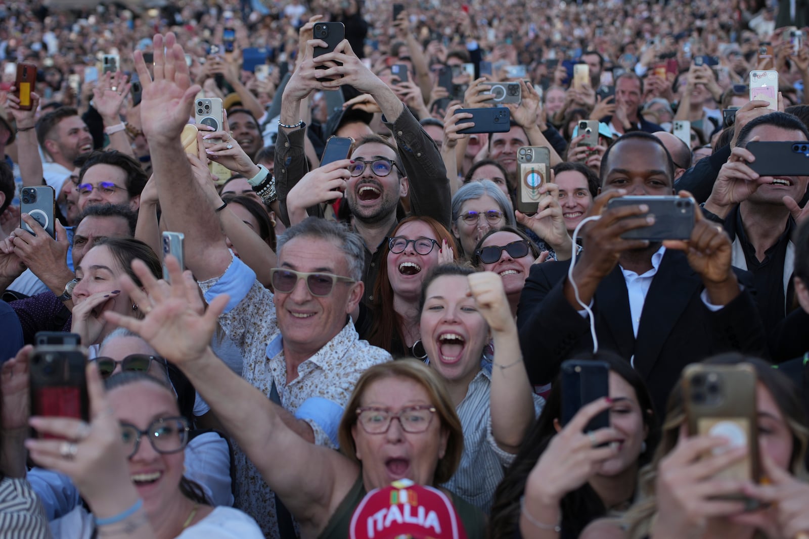People react as the newly elected Pope Leo XIV he appears at the balcony of St. Peter's Basilica at the Vatican, Thursday, May 8, 2025. (AP Photo/Emilio Morenatti)