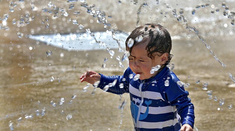 Jaxon Moon runs from one water feature to another Tuesday, June 15, 2022 as he plays on the Snyder Park Sprayground. BILL LACKEY/STAFF
