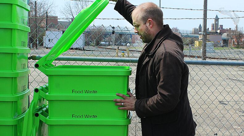 Econopia owner adjusts containers that will bring discarted food to his composting site. JEFF GUERINI/STAFF