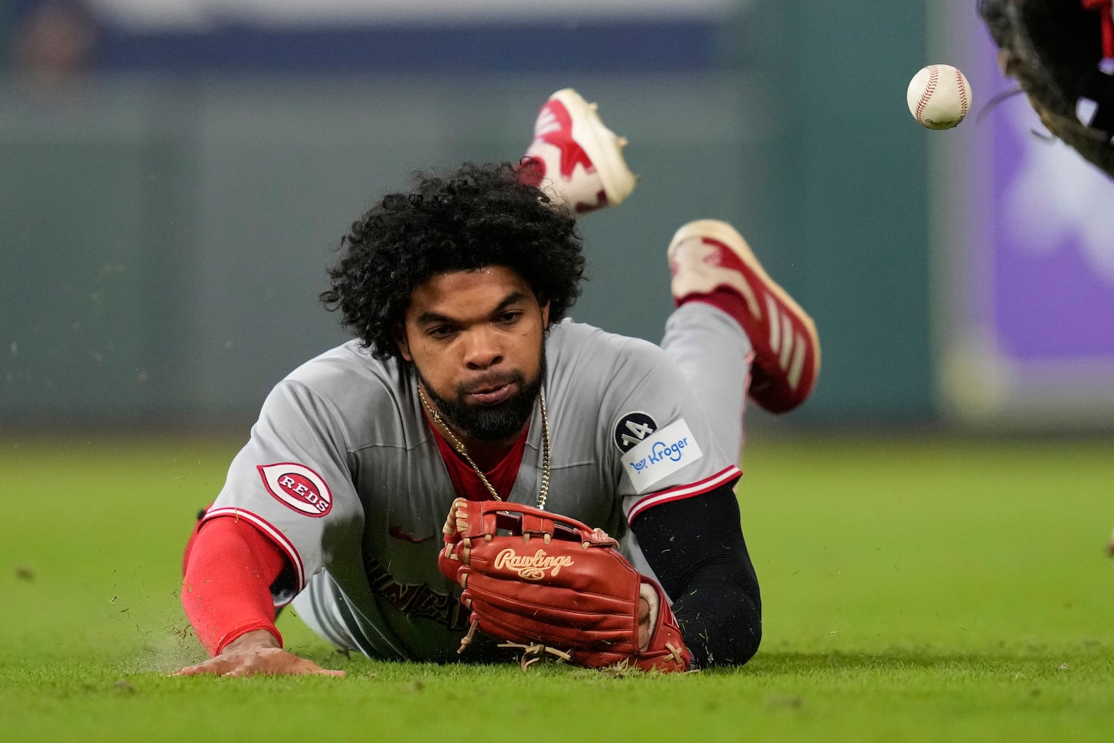 Cincinnati Reds right fielder Rece Hinds (57) dives to attempt to catch a fly ball hit by Houston Astros' Jeremy Pena during the first inning of a baseball game in Houston, Friday, May 9, 2025. (AP Photo/Ashley Landis)