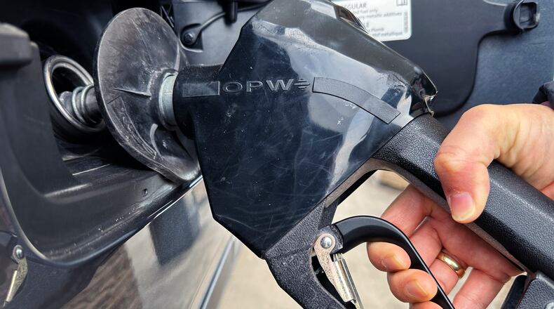 FILE - A customer pumps gas at a gas station in Mundelein, Ill., Feb. 8, 2024. (AP Photo/Nam Y. Huh, file)